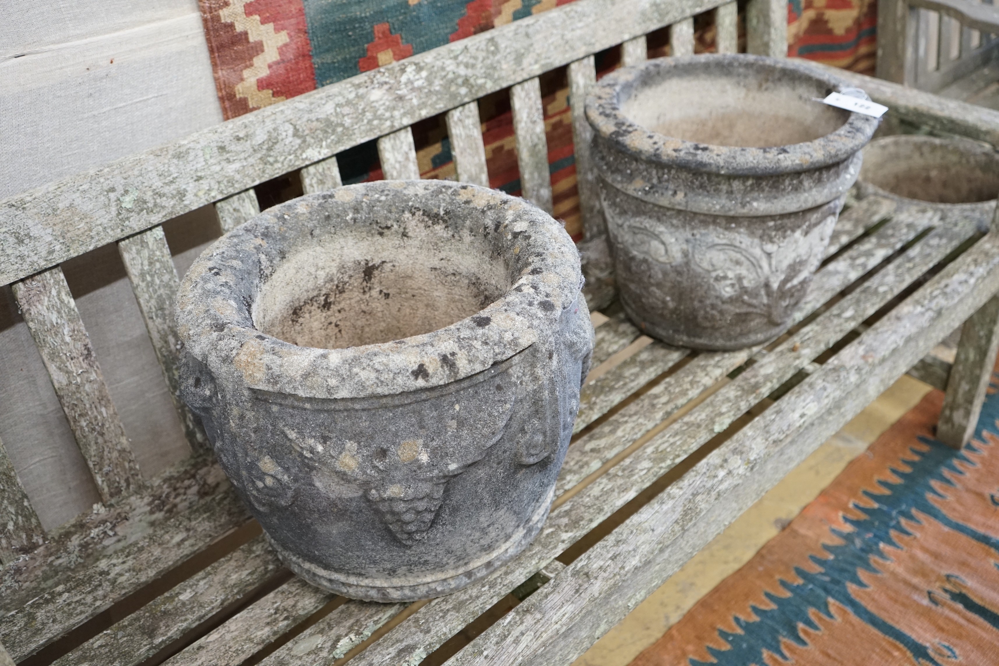 Three circular reconstituted stone garden planters, largest diameter 40cm, height 32cm